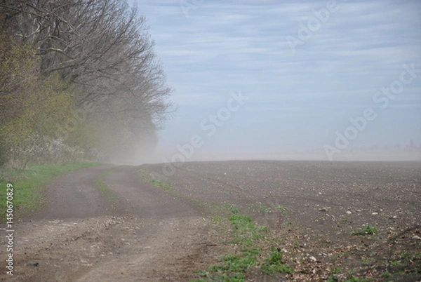 Fototapeta poor visibility in the field due to a dust storm