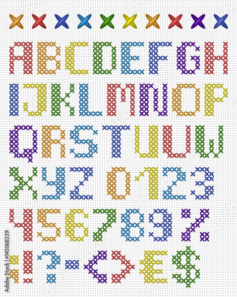 Fototapeta Colorful cross stitch uppercase english alphabet with numbers and symbols. Isolated on white cloth texture