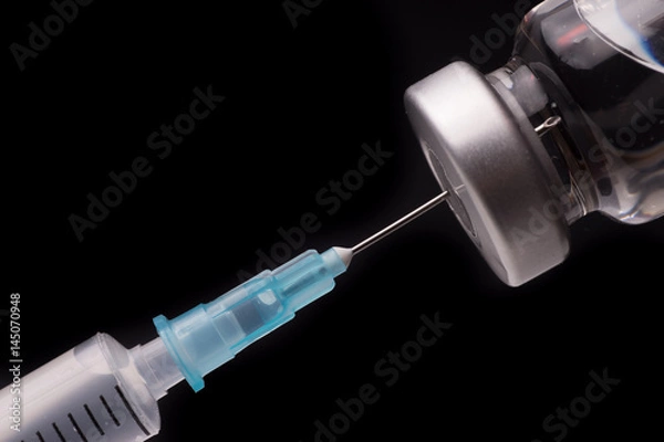 Fototapeta Medical syringe with the needle in the vial