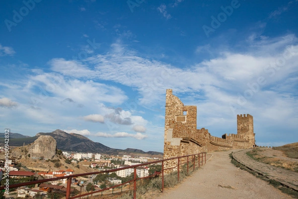 Obraz a ruined historical ancient fortress stands against the backdrop of a modern city