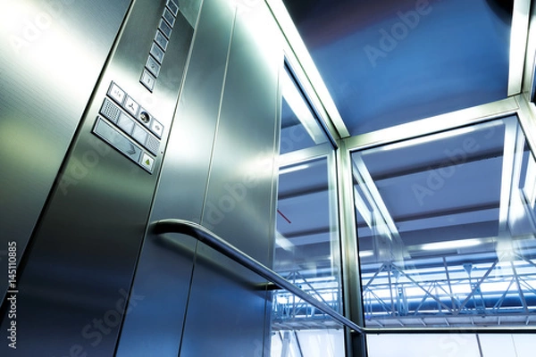 Obraz Inside metal and glass Elevator in modern building , the shiny buttons and railings