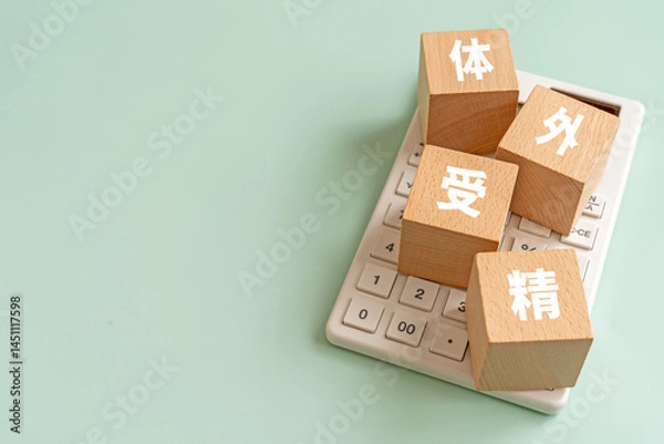 Obraz 体外受精と書かれたブロックと電卓