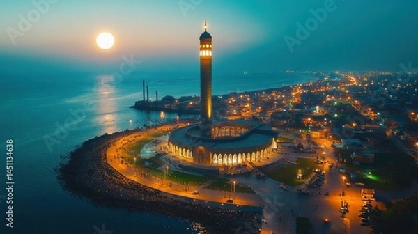 Fototapeta Coastal Mosque at Dusk, Aerial View, Illuminated Cityscape