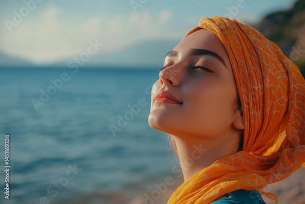 Fototapeta Girl with a headscarf enjoying summer at the beach