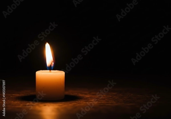 Fototapeta A solitary candle illuminates the darkness with its soft, flickering flame, creating a calming and serene atmosphere full of warmth and tranquility