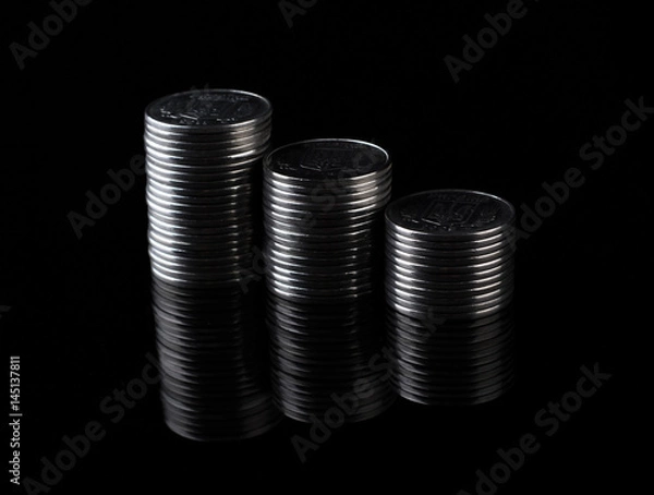 Obraz Mirror coins reflection on black background