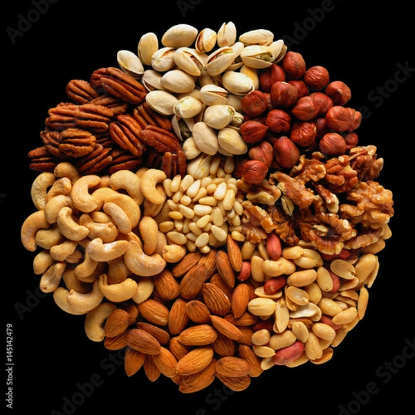 Fototapeta Assorted nuts in the form of a circle (peanuts, almonds, hazelnuts, pine nuts, cashews, walnuts, pistachio) isolated against the black background.