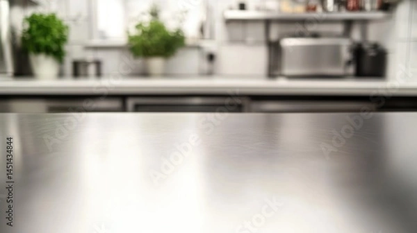 Fototapeta Empty stainless tabletop with blurred kitchen view background.