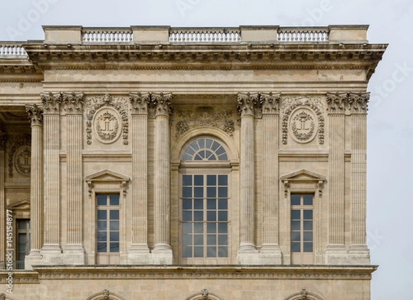 Obraz Corner part of the Louvre Museum facade with details of the windows and embedded columns on this beautiful baroque architectural landmark