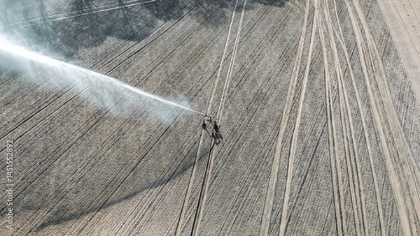 Fototapeta Aerial drone view of irrigation system, water jet rain guns sprinklers on field, rural scene landscape on sunny day, field background, agriculture in the Netherlands