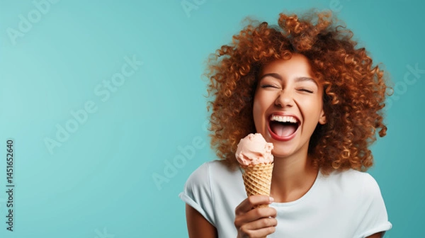 Obraz Young woman enjoying with ice cream cone, happy and joyful, blue background with text space.