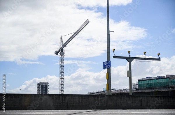 Fototapeta Construction crane above the building under construction. HEIGHT CHECK sign on the post. Auckland.