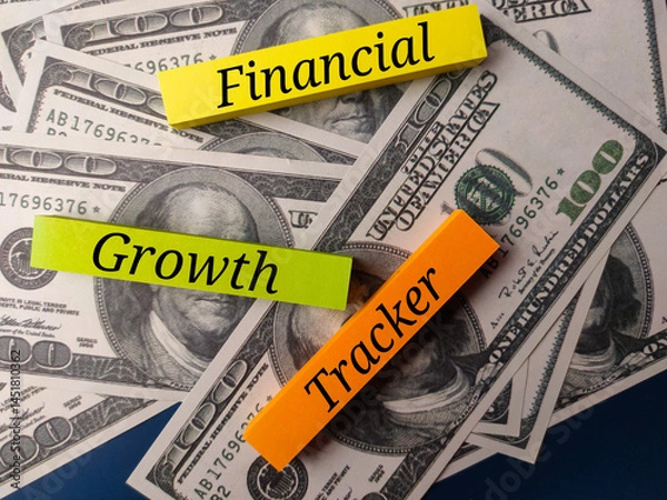 Fototapeta Sticky note with the word Financial Growth Tracker on a banknotes
