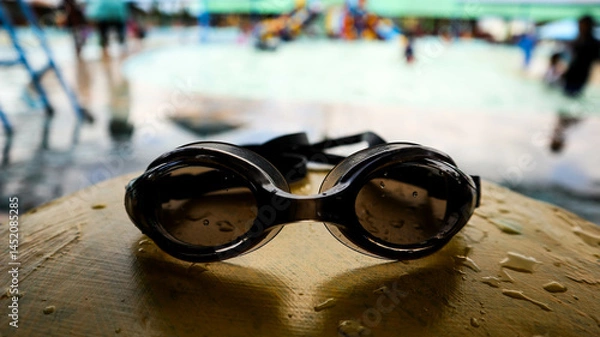Obraz Black swimming goggles with water droplets