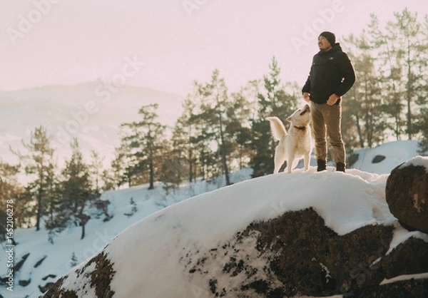 Obraz A man and his dog at the top of a mountain