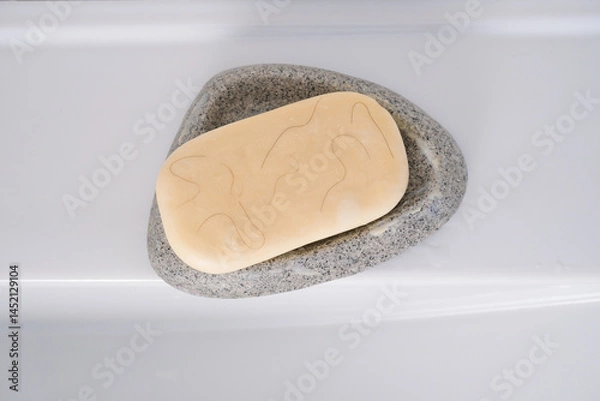 Fototapeta White soap in a soap dish with hair on the sink