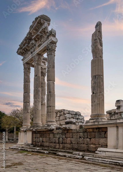 Fototapeta The warm glow of the sunset illuminates the impressive columns and historical significance of the Temple of Trajan in Pergamon, Izmir, Turkey