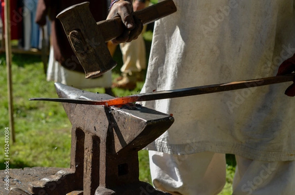 Obraz ancient blacksmithing historical reenactment, iron age, sparks hot iron