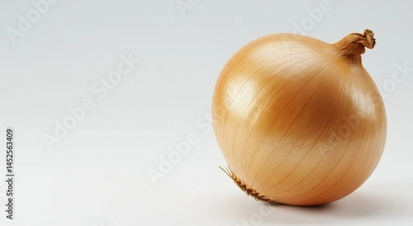 Fototapeta Close-up of a fresh, shiny yellow onion on a light background