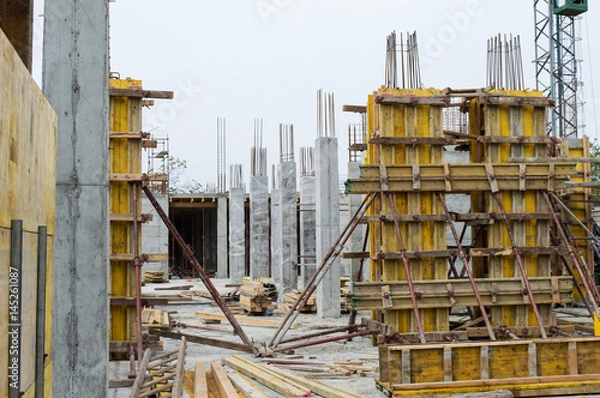 Obraz Concrete Pillars Supported With Boards on Construction Site