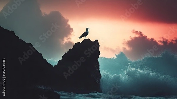 Fototapeta A silhouette of a seagull balancing on a jagged coastal rock near crashing waves