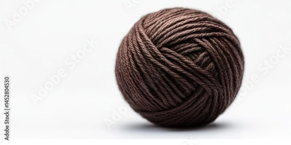 Fototapeta Close-up of a brown ball of yarn on white background