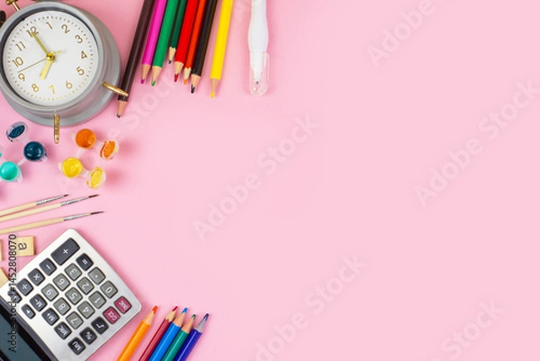 Obraz A Bright and Colorful Collection of Office Supplies Arranged on a Pink Background Surface