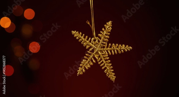Fototapeta Golden Snowflake Christmas Ornament with Bokeh Lights on Dark Background