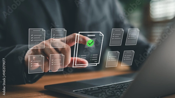 Obraz Businessman finger selecting digital document with check mark icon, representing paperless workflow, document management, approval process, e-signature and modern business operation.