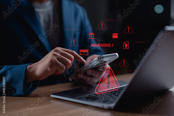 Obraz Businessman receiving cybersecurity warning on smartphone with system hack alerts. Concept of data breach, hacking, online security risk, cyberattack, and internet safety technology.
