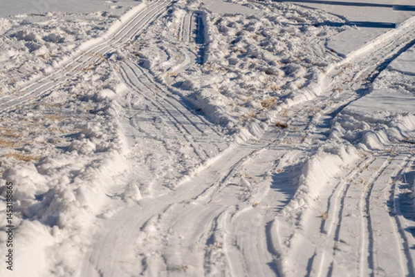 Fototapeta Selective focus on the snow path on the top of a hill in a backyard 