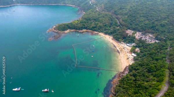 Fototapeta May 1 2025 Secluded Beach with Boats and Dense Forest Surrounding