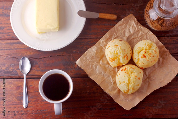Fototapeta homemade cheese bread, traditional Brazilian snack, on the breakfast table in a rustic farm kitchen