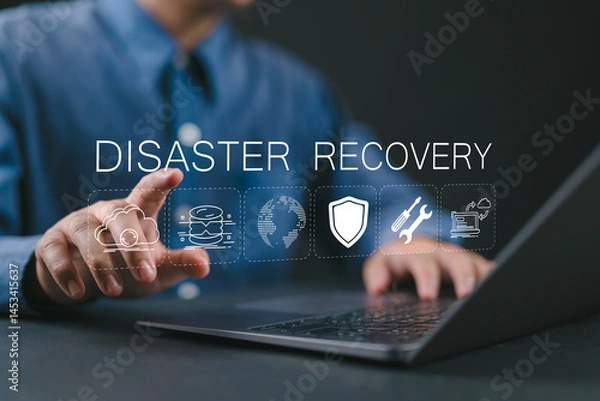 Fototapeta Disaster recovery concept, IT system protection. Man using laptop with disaster recovery icon on virtual screen. Restoring critical systems and data.