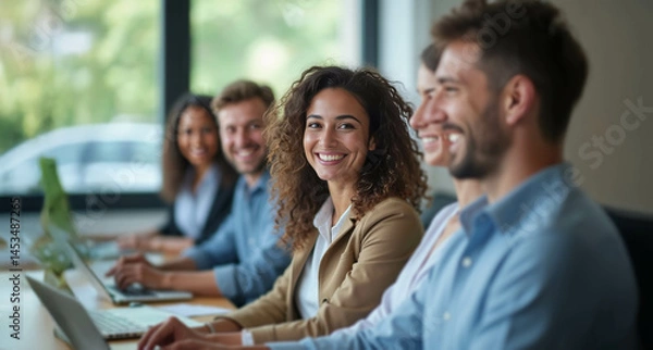 Fototapeta A diverse group of confident professionals smiling in a bright modern office, exuding positivity and tech-savvy collaboration.