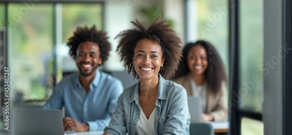 Fototapeta A diverse group of confident professionals smiling in a bright modern office, exuding positivity and tech-savvy collaboration.