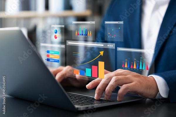 Fototapeta Businessman analyzing data with hologram dashboard graphs on laptop, symbolizing business growth, data analytics, financial performance, marketing strategy, and future digital transformation.