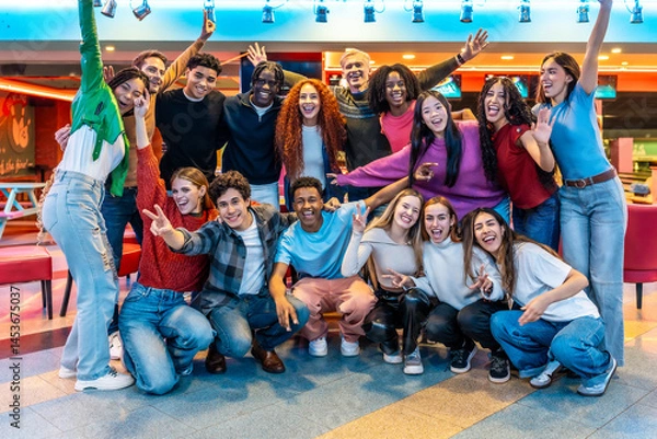 Fototapeta Happy multiethnic friends enjoying bowling alley games