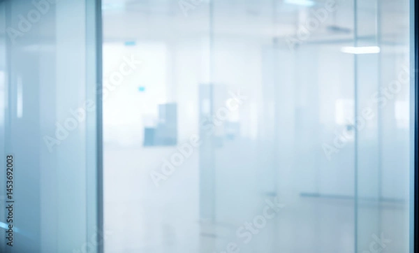Fototapeta Blurred interior view through glass walls depicting a modern office space.