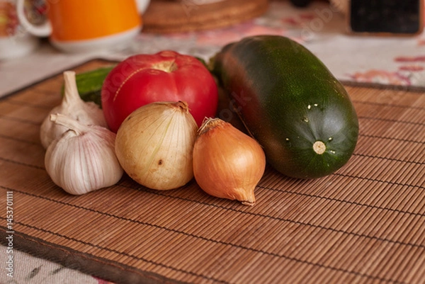 Fototapeta Fresh vegetables on the table. garlic, tomato, zucchini onion, marrow, potatoes, cucumber.