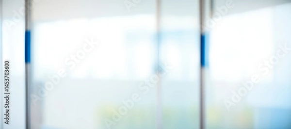 Fototapeta Blurred abstract background with white light and blue accents in a building.