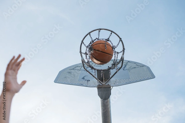 Fototapeta Ball is about to fall into basket