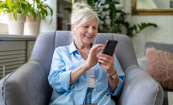 Obraz Senior woman using mobile phone at home
