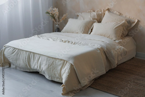Obraz In a cozy bedroom, there is a neatly made bed adorned with crisp white sheets and fluffy pillows, inviting a restful sleep