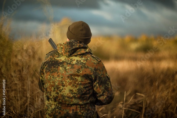 Fototapeta Hunter in camouflage jacket on hunting in anticipation of prey