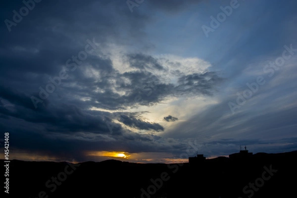 Obraz Sunset with partly cloudy sky. Dramatic sky