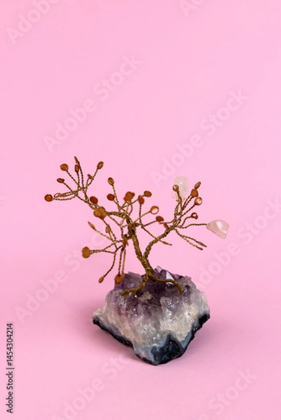 Fototapeta Crystal tree with rose quartz crystals on an amethyst base