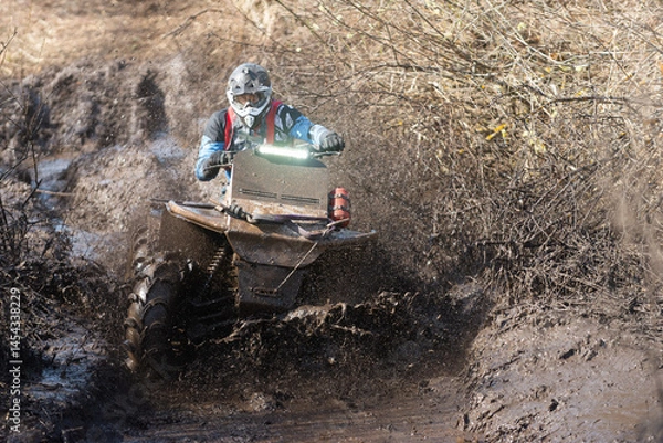 Fototapeta A powerful ATV epically overcomes off-road conditions.