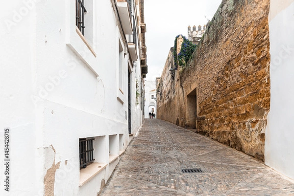 Fototapeta a cobbled street with typical white houses in Arcos de la Frontera, province of Cádiz, Andalusia, Spain