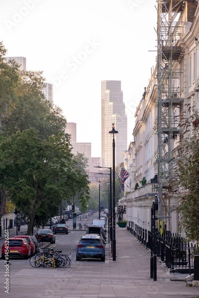 Obraz A vibrant urban street scene showcasing modern architecture alongside lush trees in the area Saint Georges Drive - London